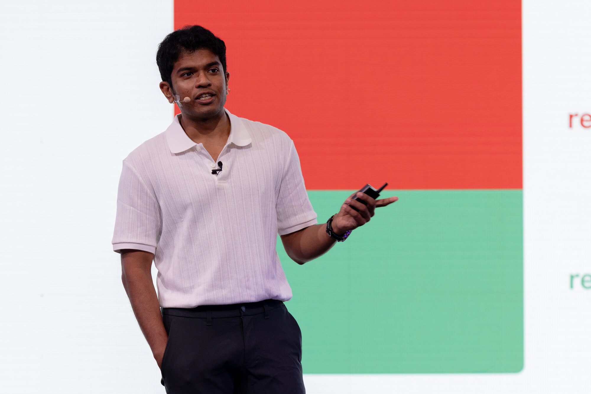 Stage photo. I'm in front of a slide showing the red/green RoI bar, mic clipped to my collar, mid-sentence.